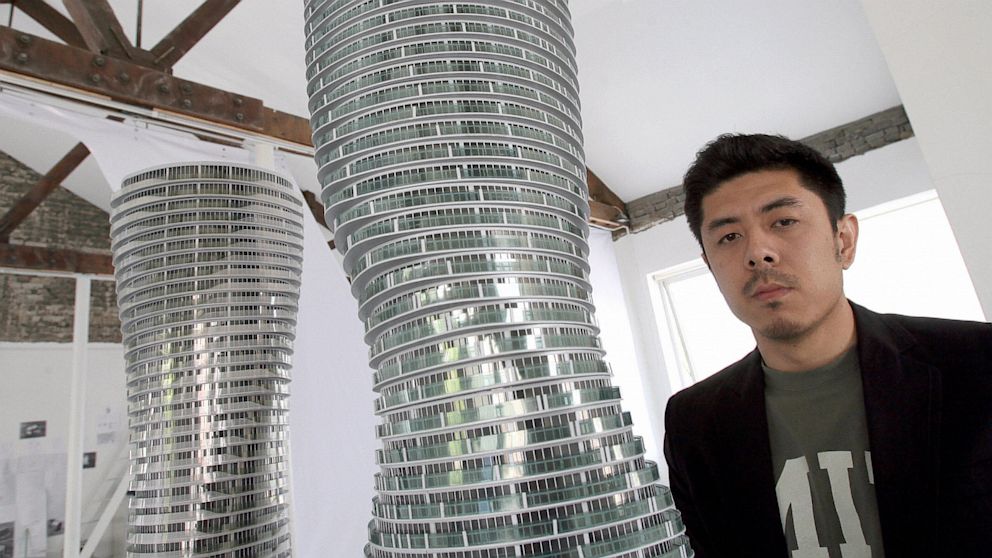 PHOTO: Chinese architect Ma Yansong poses next to his Marilyn Monroe Buildings models