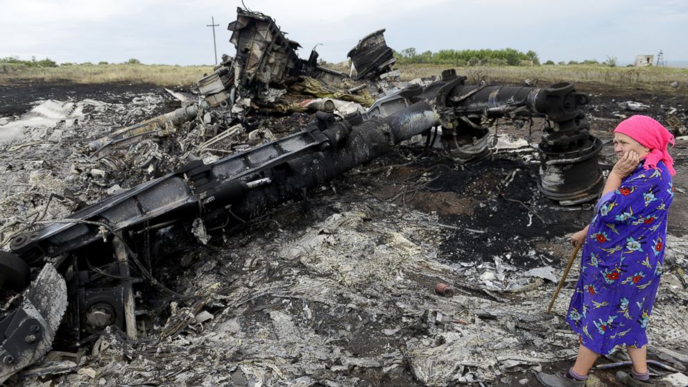 A local resident stands among the wreckage at the site of the crash of a Malaysia Airlines plane carrying 298 people from Amsterdam to Kuala Lumpur in Grabove, in rebel-held east Ukraine, on July 19, 2014.