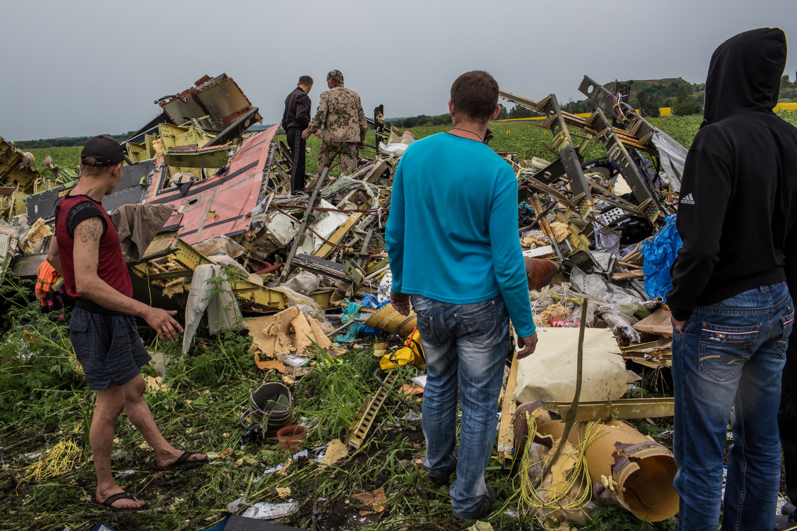 PHOTO: A group of people are pictured looking at the wreckage of Malaysia Airlines Flight 17 on July 18, 2014 in Grabovka, Ukraine.
