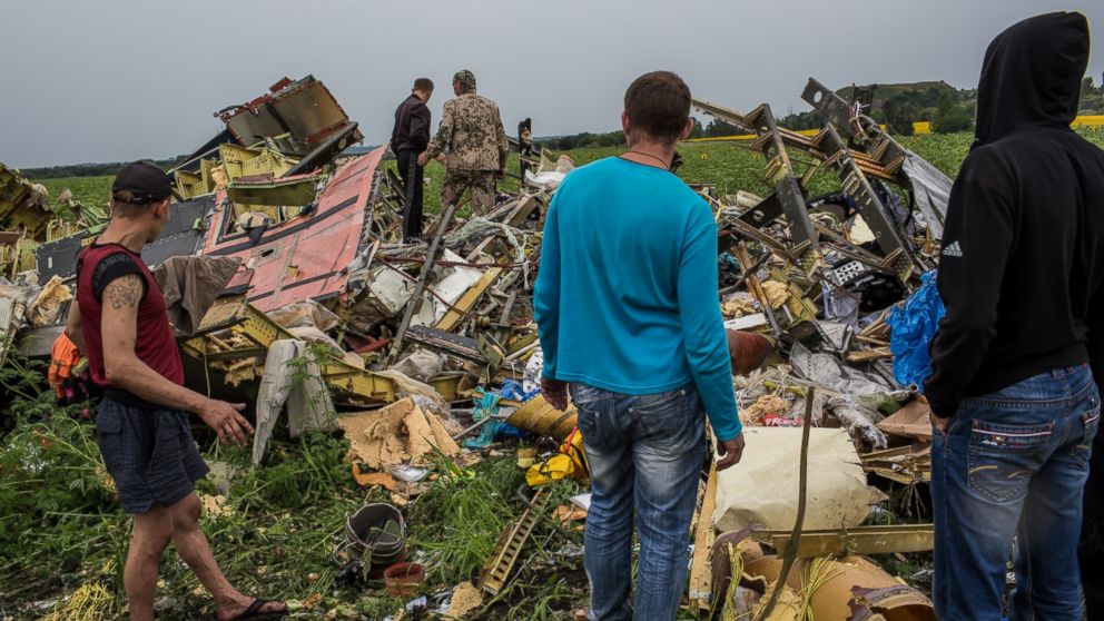 A group of people are pictured looking at the wreckage of Malaysia Airlines Flight 17 on July 18, 2014 in Grabovka, Ukraine.
