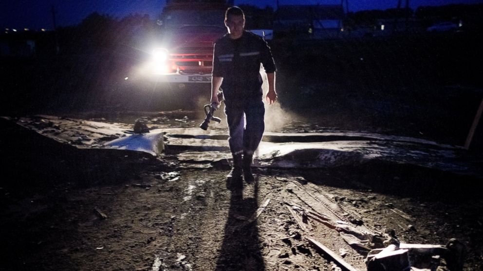 Debris from Malaysia Airlines Flight 17 is shown smoldering in a field on July 17, 2014 in Grabovo, Ukraine.