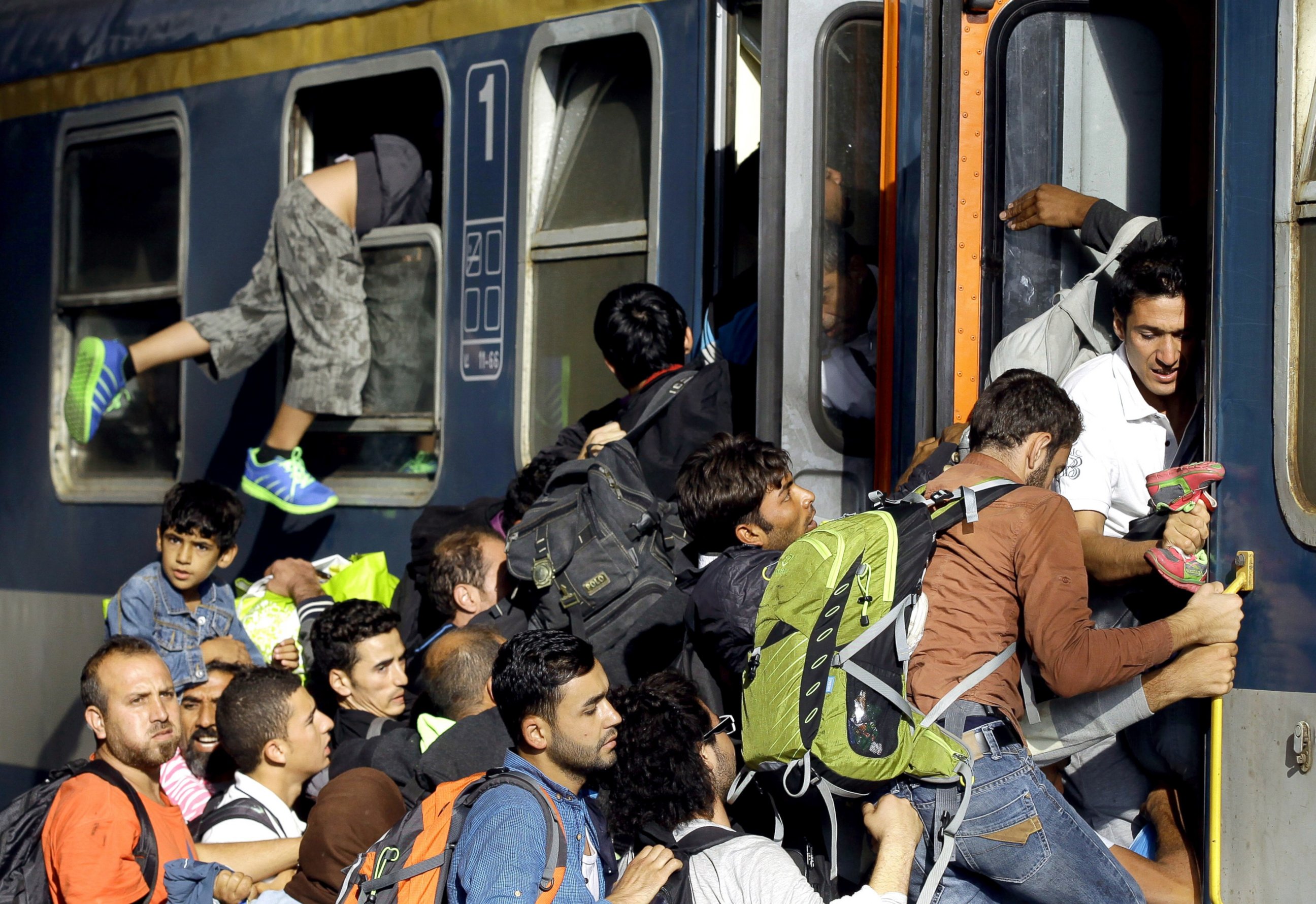 PHOTO: Migrants board into a local train heading to the Hungarian-Austrian border at the main train station in Budapest, Sept. 3, 2015, after authorities re-opened the station to refugees. 