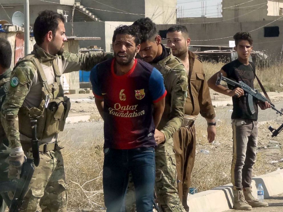 PHOTO: Iraqi Kurdish security forces detain a suspected member of the Islamic State (IS) group as they patrol the eastern suburbs of Kirkuk on Oct. 22, 2016, after jihadist gunmen attacked the city.