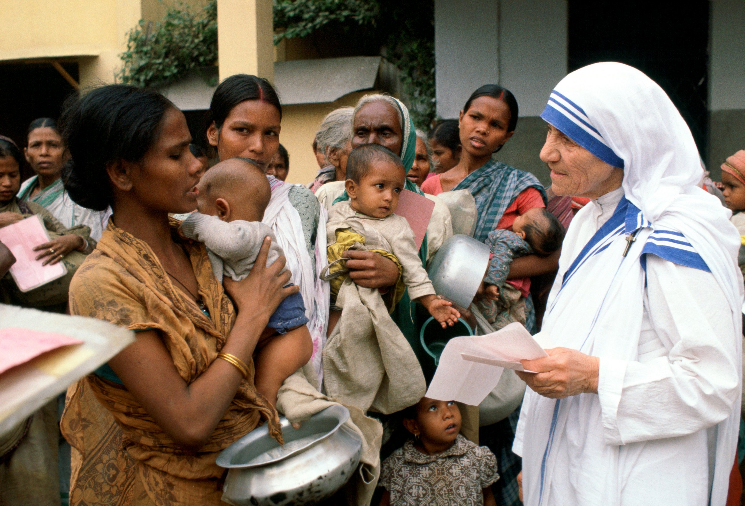 PHOTO: Mother Teresa with mothers and children at her Mission in Calcutta, India.