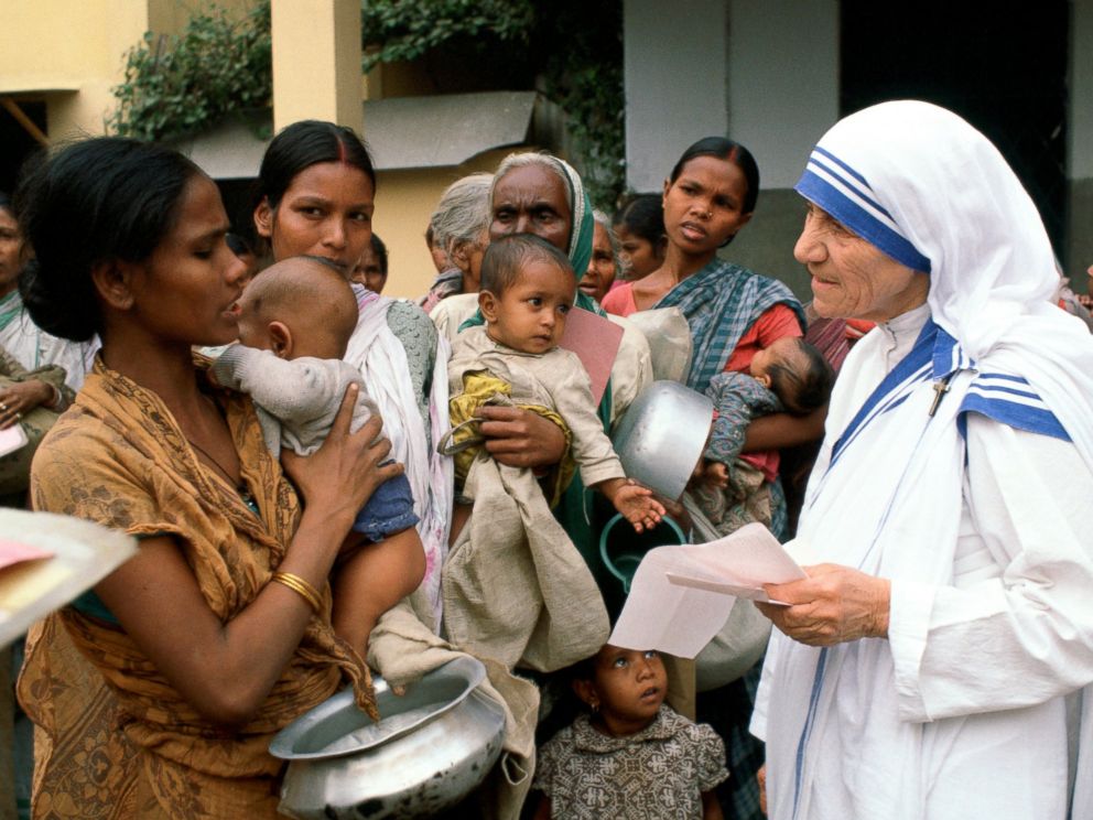 PHOTO: Mother Teresa with mothers and children at her Mission in Calcutta, India.