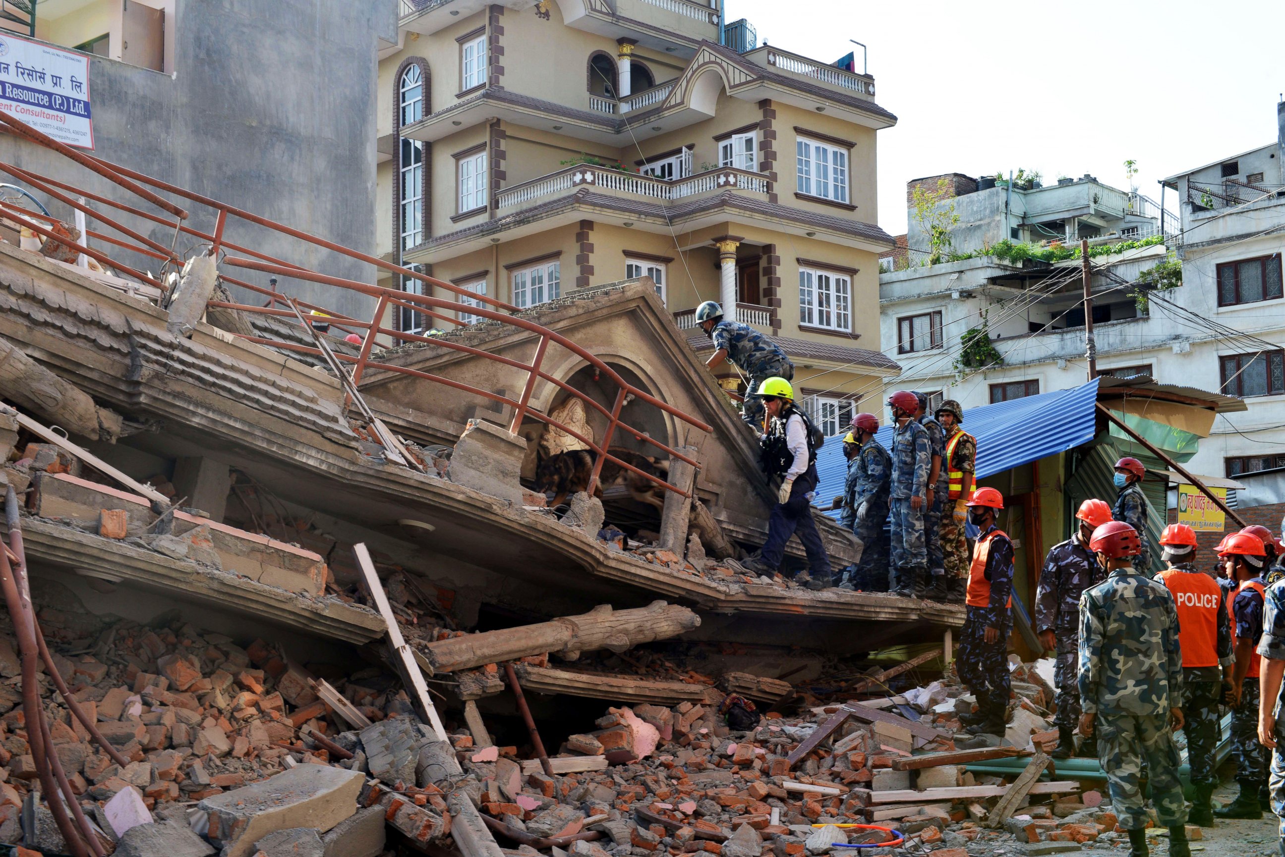 PHOTO: U.S. rescue team officials with a sniffer dog search for survivors at a collapsed house in Kathmandu on May 12, 2015, after an earthquake struck.