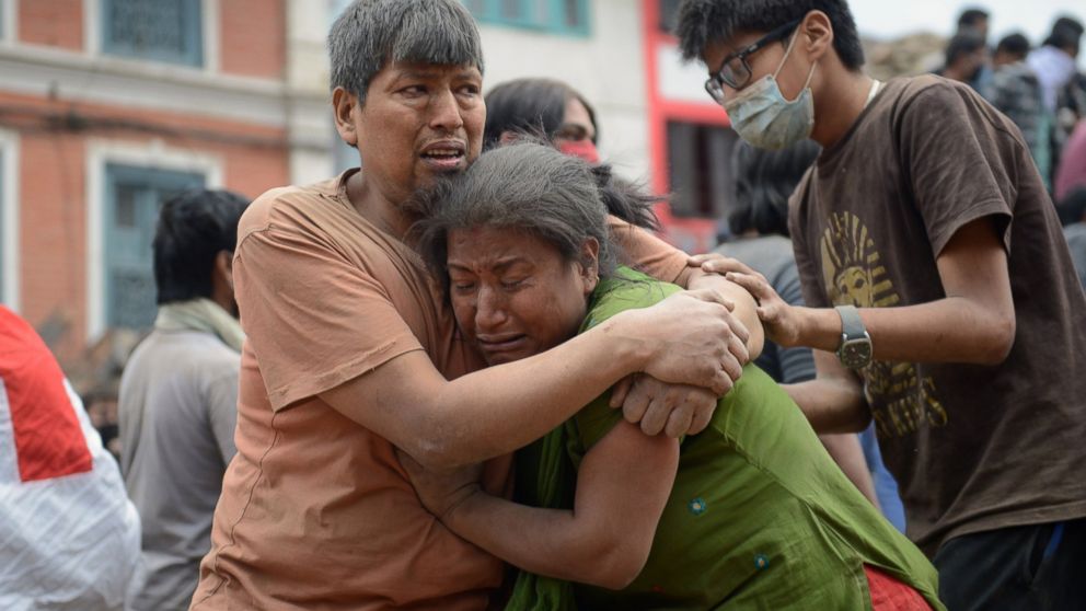 A Nepalese man and woman hold each other in Kathmandu's Durbar Square, a UNESCO World Heritage Site that was severely damaged by an earthquake on April 25, 2015. 
