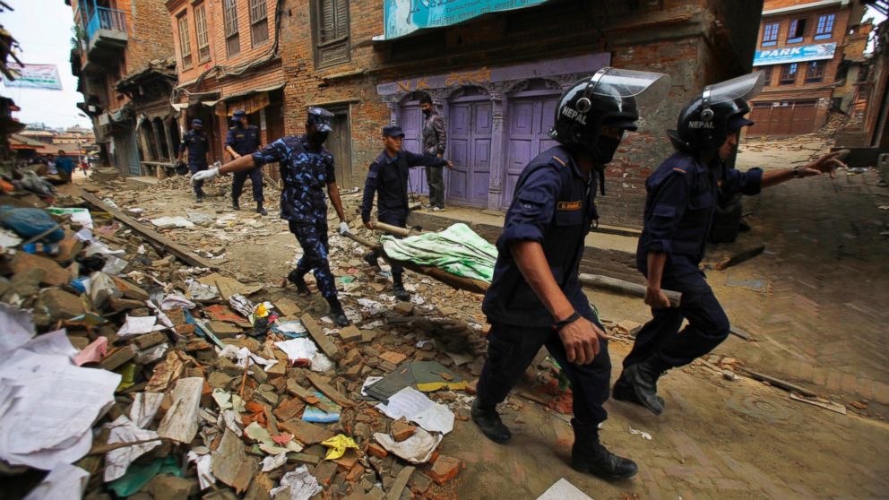 PHOTO: Nepalese rescue team carry on a stretcher the body of a victim recovered from the debris of a building that collapsed after an earthquake in&nbsp;Bhaktapur, near Kathmandu, Nepal, Sunday, April 26, 2015. 