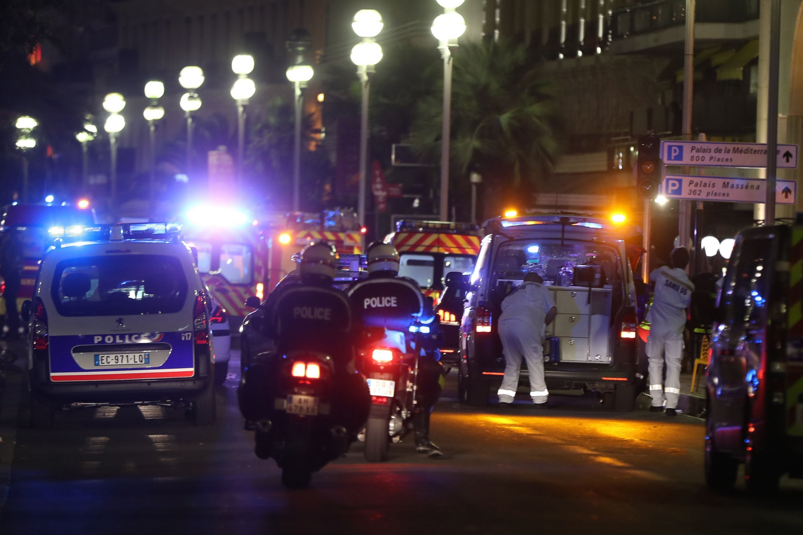 PHOTO: Police officers and rescue workers arrive at the scene of an attack, July 14, 2016, after a van ploughed into a crowd leaving a fireworks display in the French Riviera town of Nice.