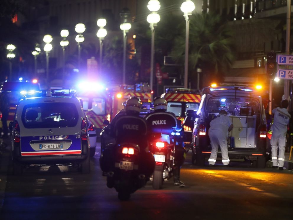 PHOTO: Police officers and rescue workers arrive at the scene of an attack, July 14, 2016, after a van ploughed into a crowd leaving a fireworks display in the French Riviera town of Nice.