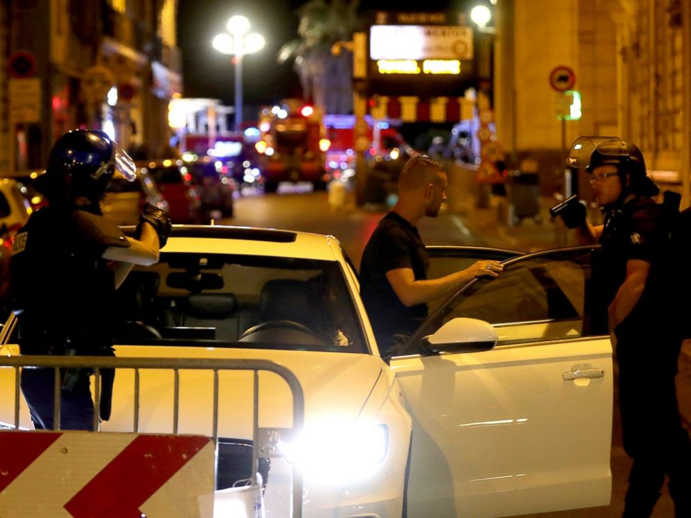PHOTO: Police officers check vehicles in the center of French Riviera town of Nice, after a van drove into a crowd watching a fireworks display on July 14, 2016.