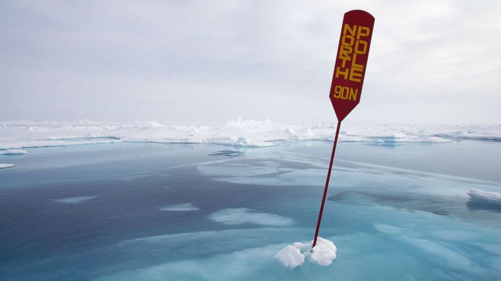 A sign indicating North Pole is seen among melting ice in this undated file photo. 