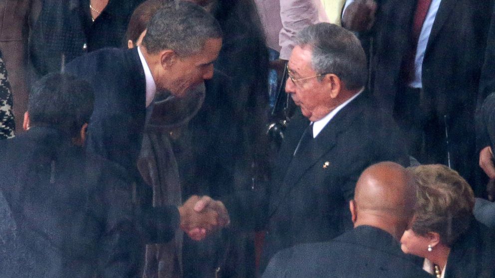 President Barack Obama shakes hands with Cuban President Raul Castro during the official memorial service for former South African President Nelson Mandela at FNB Stadium, Dec. 10, 2013, in Johannesburg, South Africa.