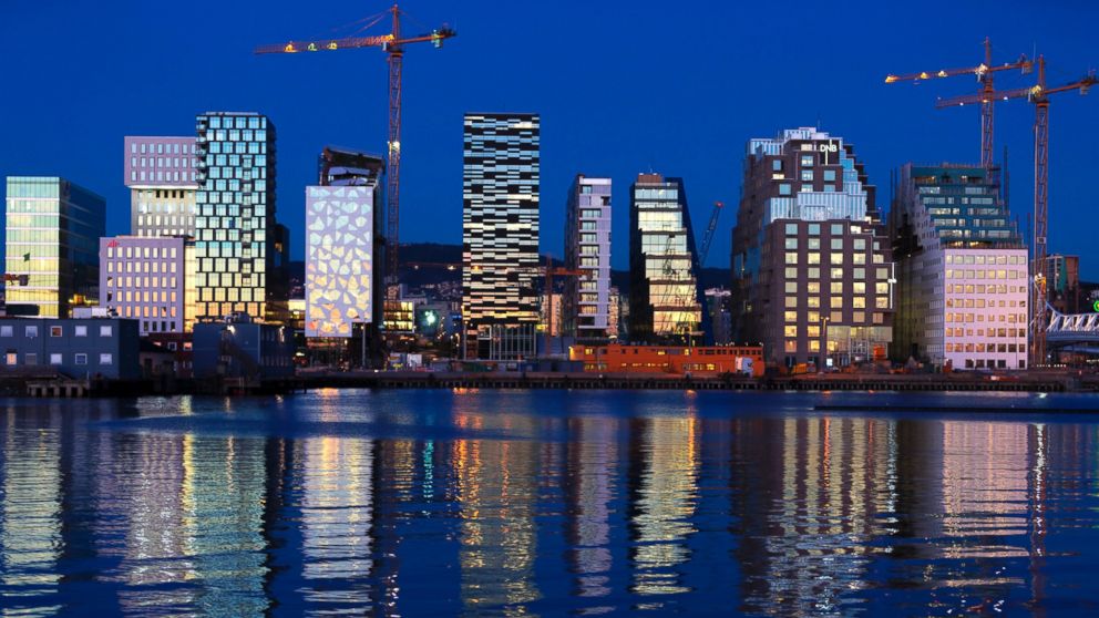 Buildings of The Barcode Project are reflected on the water at sunset in Oslo, Nov. 18, 2012.