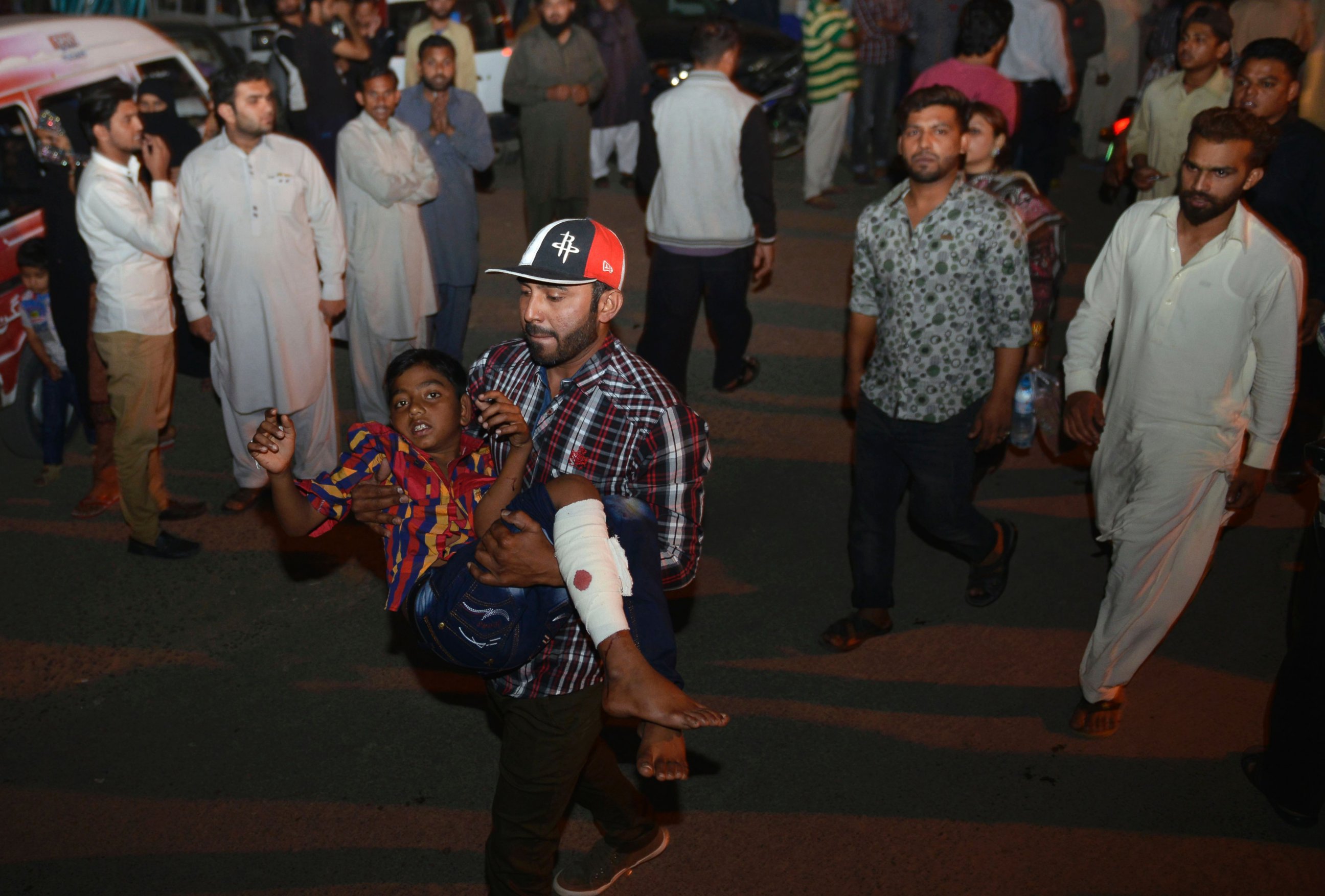 PHOTO: A Pakistani relative carries an injured child to the hospital in Lahore, March 27, 2016, after an apparent suicide bomb ripped through the parking lot of a crowded park in the Pakistani city of Lahore where Christians were celebrating Easter.