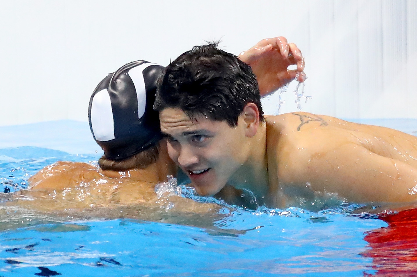 PHOTO: Joseph Schooling of Singapore celebrates winning gold with Michael Phelps of the United States in the Men's 100m Butterfly Final on Day 7 of the Rio 2016 Olympic Games at the Olympic Aquatics Stadium, Aug. 12, 2016, in Rio de Janeiro.
