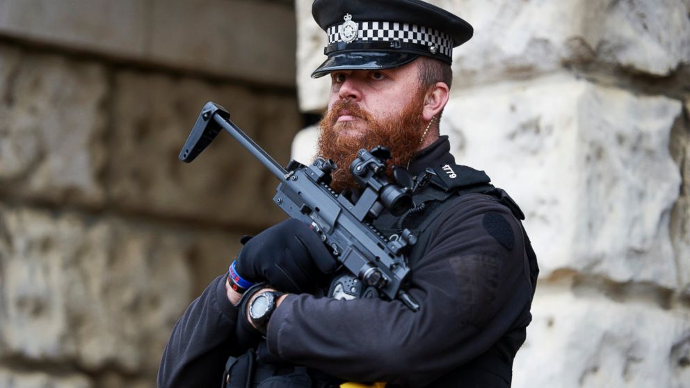In this file photo, an armed British police officer stand on duty in central London, Nov. 25, 2015. 