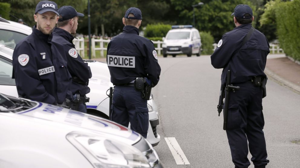 French police officers stand on the street in Magnanville, June 14, 2016, where a man claiming allegiance to the Islamic State group killed a French policeman and his partner on the night of June 13.
 