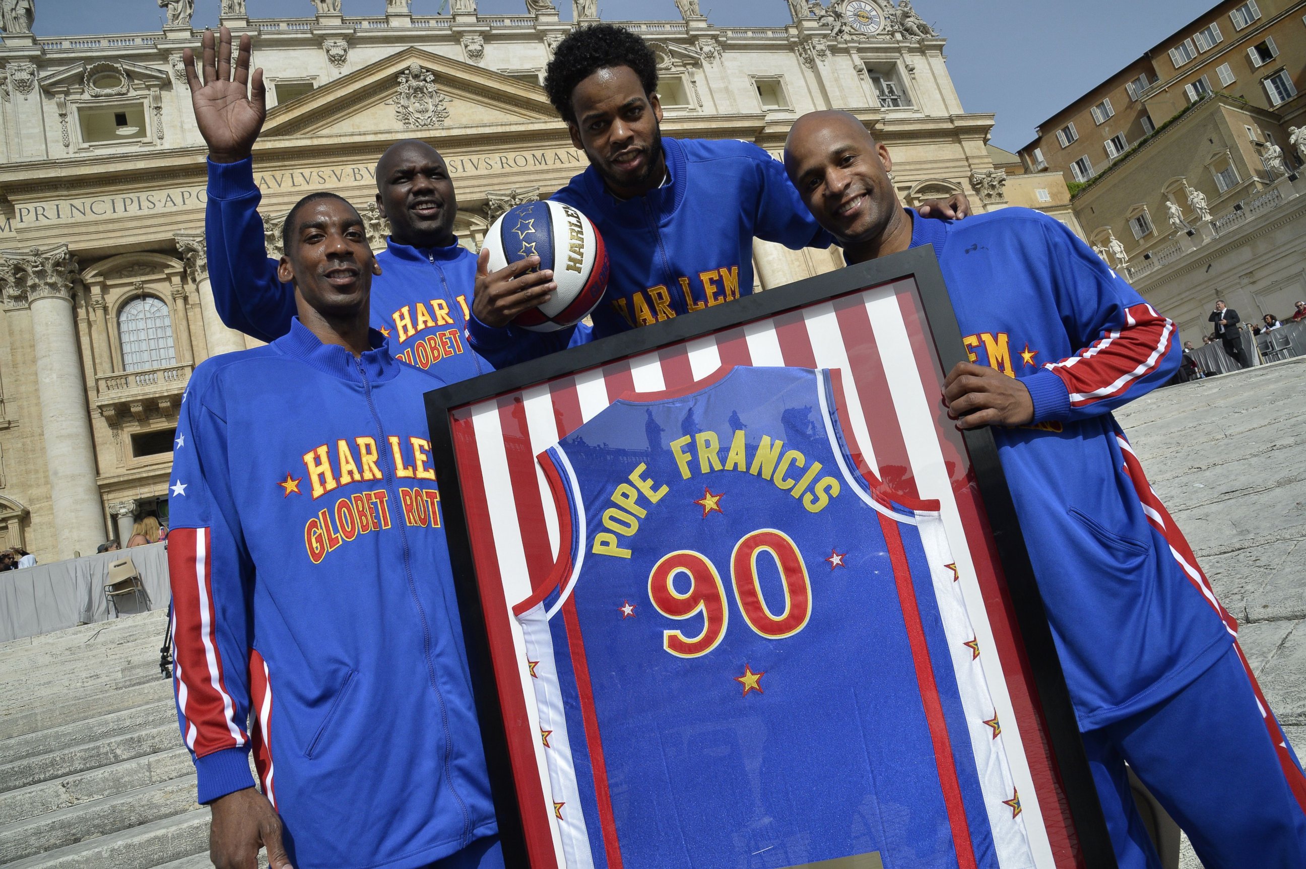 PHOTO: Members of the Harlem Globetrotters basketball team pose before the arrival of Pope Francis for his weekly general audience at St Peter's square, May 6, 2015, at the Vatican.