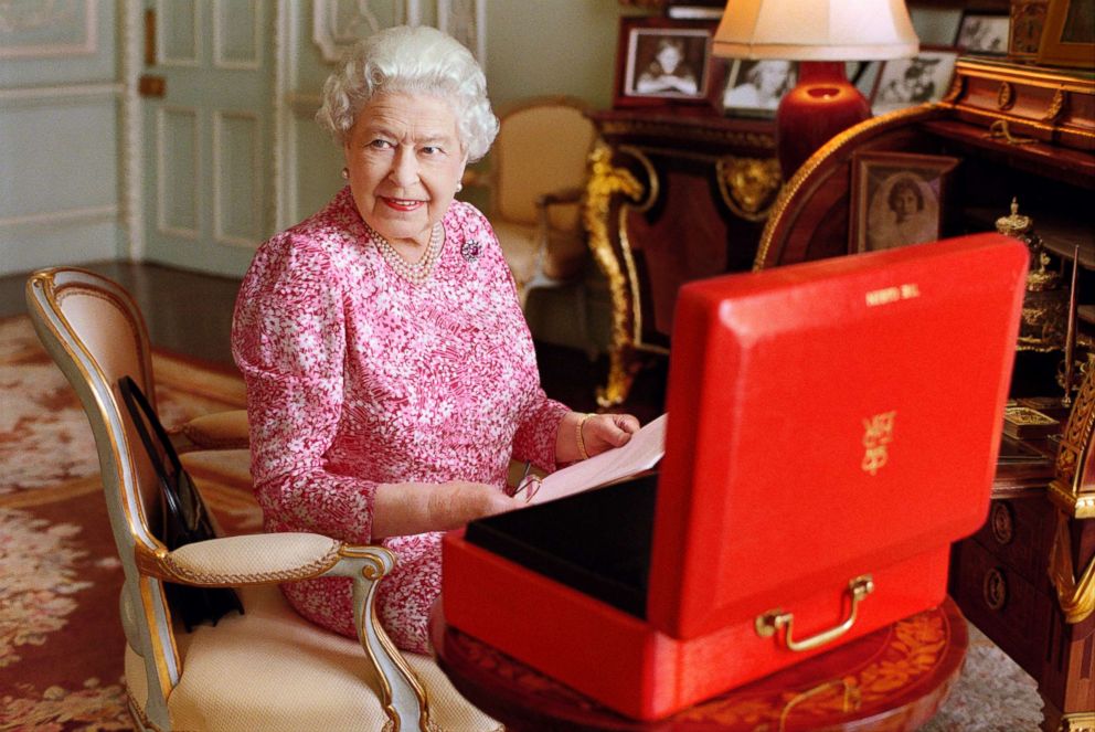 PHOTO: Queen Elizabeth II is seated at her desk in her private audience room at Buckingham Palace with one of her official red boxes in this photo released Sept. 8, 2015.