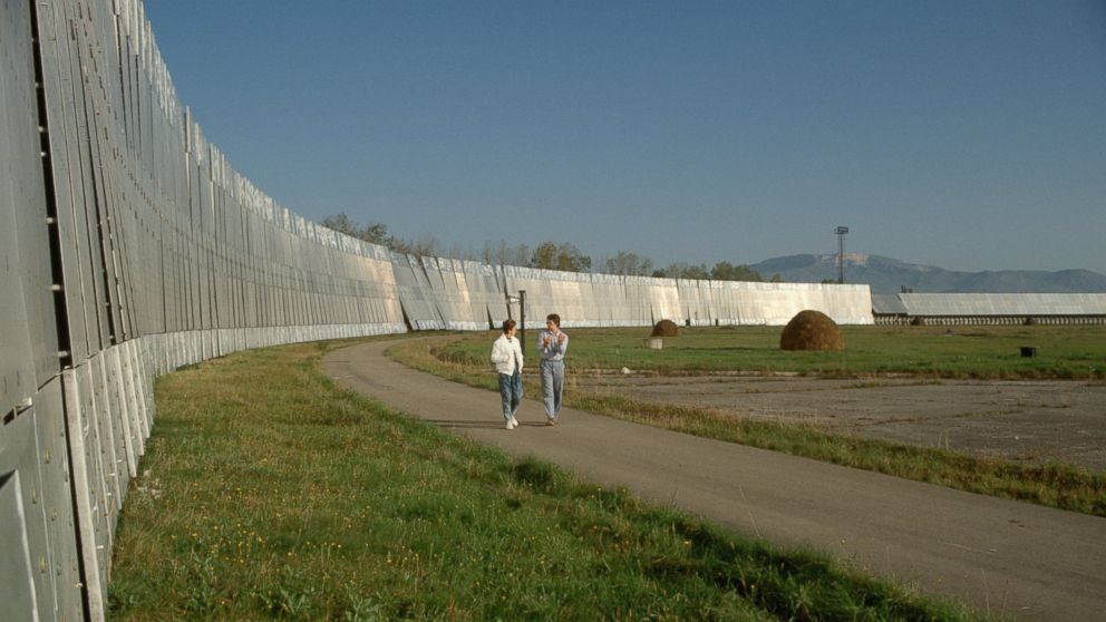 Olga Verkina, left, and Valentin Lipovetsky walk past the reflector antennas of the RATAN-600 radio telescope near Zelenchukskaya, Russia.