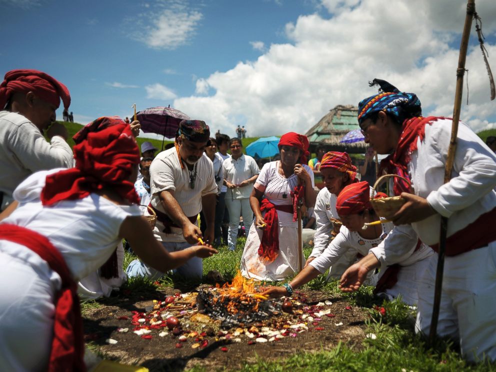 PHOTO: Members of the Mayan Priest Council make an offering during a ceremony