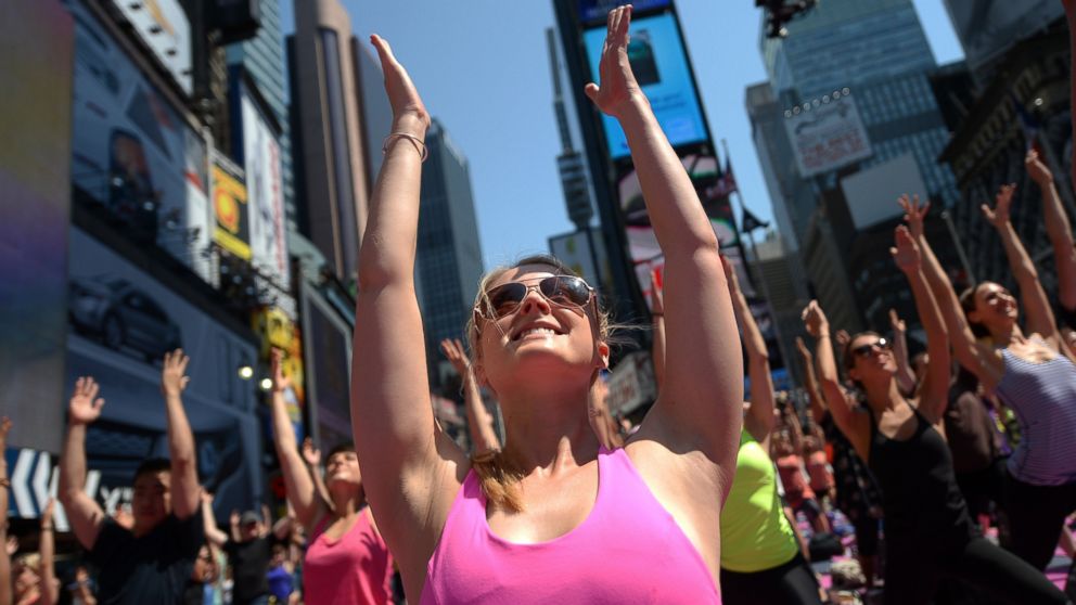 Participants practice yoga as part of a series of mass yoga classes in Times Square to celebrate the summer solstice in New York, June 21, 2013.