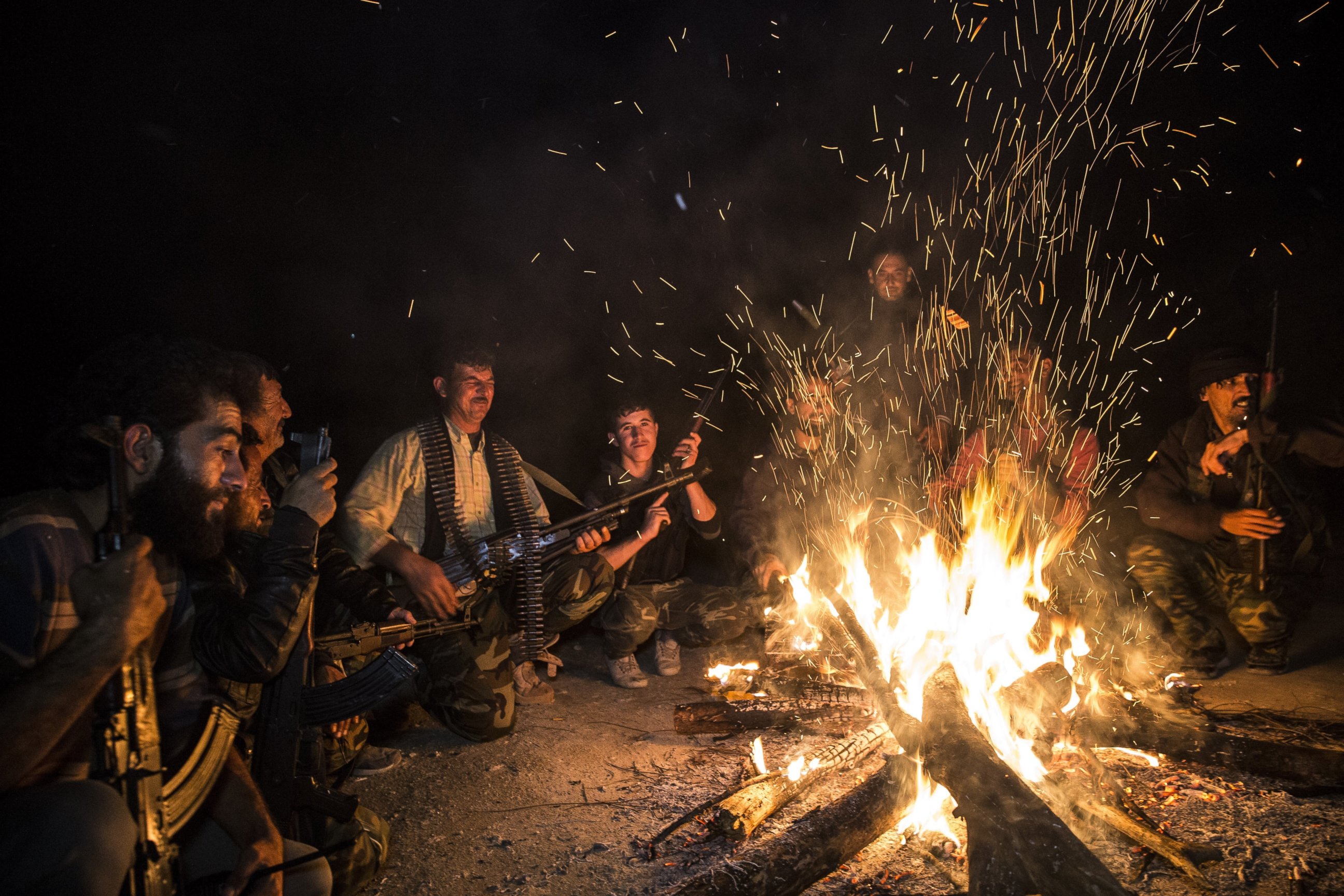 PHOTO: Turkmen soldiers gather around fire at night in the Bayirbucak region in Syria, Oct. 27, 2015. 