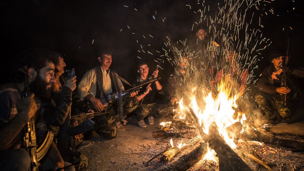 PHOTO: Turkmen soldiers gather around fire at night in the Bayirbucak region in Syria, Oct. 27, 2015. 