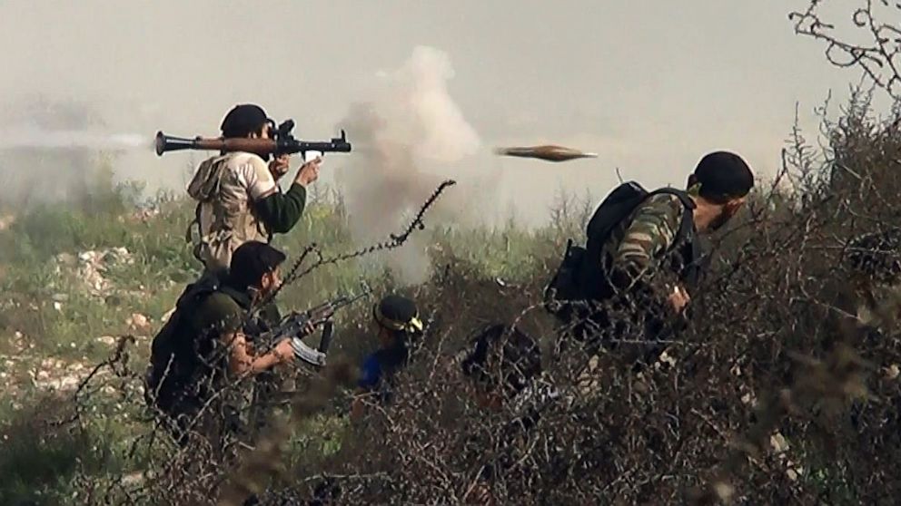 An image grab taken from a video shows an opposition fighter firing a rocket propelled grenade (RPG), Aug. 26, 2013, during clashes with regime forces over the strategic area of Khanasser, situated on the only road linking Aleppo to central Syria.