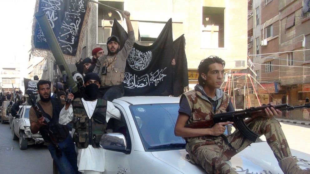 Islamic fighters from the al-Qaida group in the Levant, Al-Nusra Front, wave their movement's flag as they parade at the Yarmuk Palestinian refugee camp, south of Damascus, Syria, to denounce Israels military offensive on the Gaza Strip, July 28, 2014. 



Israeli shells struck a UN school in Gaza early today, killing 16, as ground troops made a signficant push into the territory despite Palestinian efforts to broker a 24-hour truce. AFP PHOTO/RAMI AL-SAYED        (Photo credit should read RAMI AL-SAYED/AFP/Getty Images)