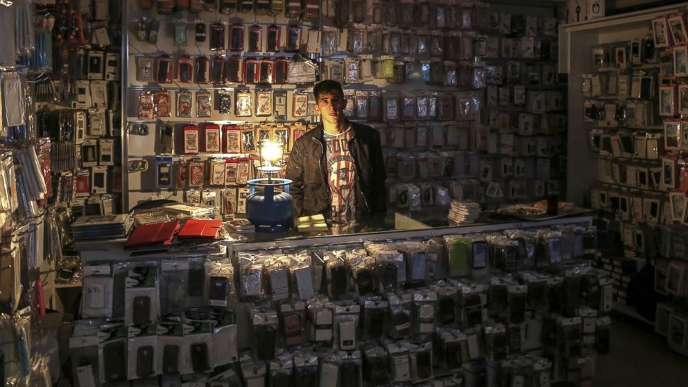 PHOTO: A salesman poses for a photo in his shop in Diyarbakir, Turkey after a major power outage