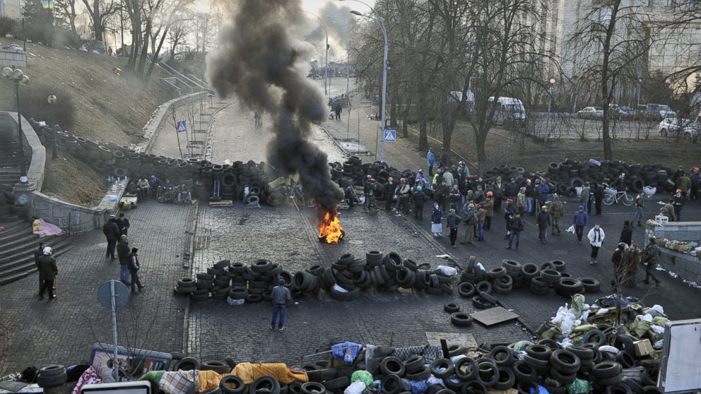 Anti-government protesters gather between barricades in central Kiev on Feb. 21, 2014.  