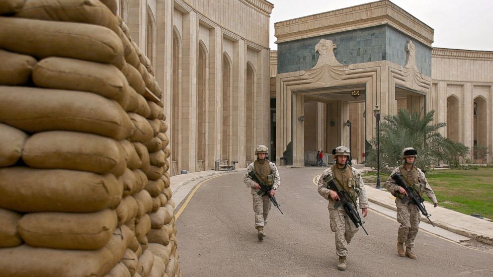 U.S. Marines walk past the front of the American Embassy, Feb. 6, 2007, in Baghdad, Iraq.
