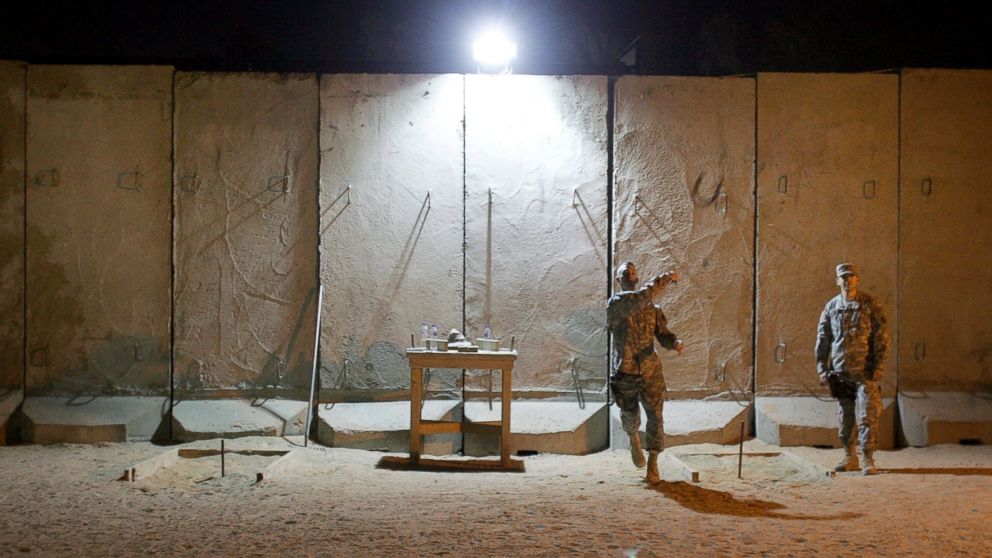 PHOTO: U.S. soldiers throw horse shoes while protected by blast walls from insurgent attacks at the American Embassy, Feb. 6, 2007, in Baghdad, Iraq.