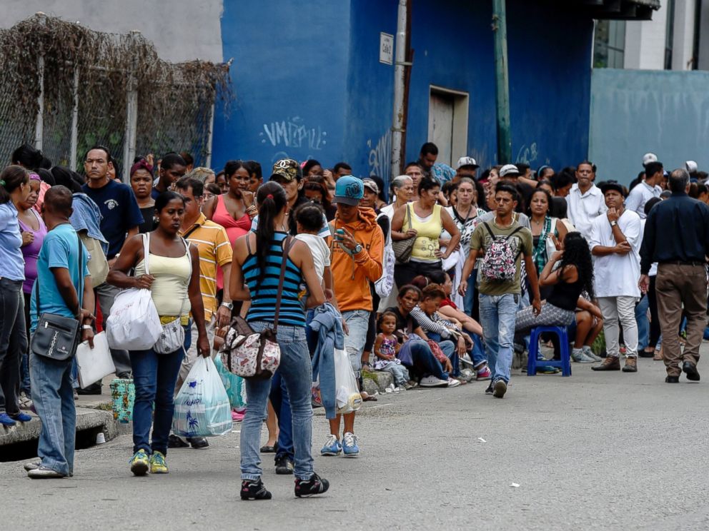 PHOTO: People queue to buy basic food and household items outside a supermarket in the Petare neighborhood in Caracas, June 1, 2016.