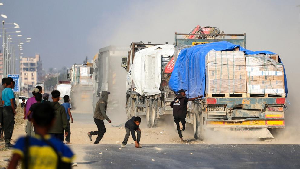 PHOTO: Displaced Palestinians are pictured next to a truck traveling along Salah al-Din road in the central Gaza Strip on Nov. 9, 2025.