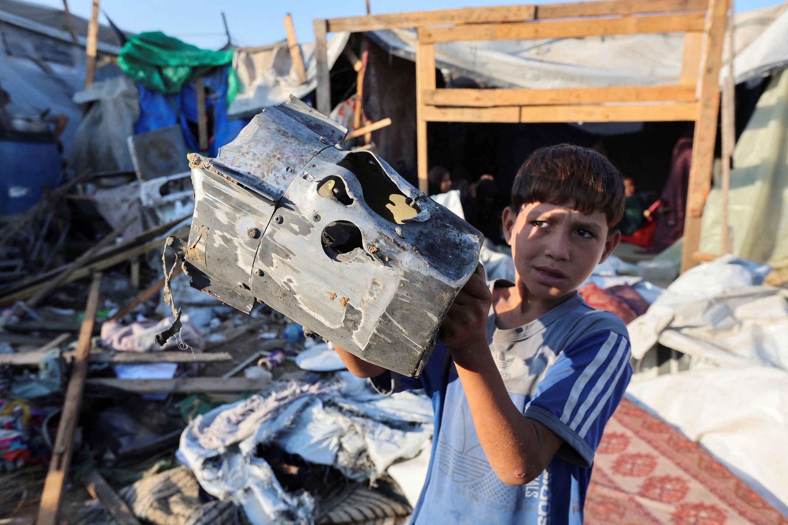 PHOTO: A Palestinian child holds the remains of a missile at the site of an Israeli strike on the courtyard of Al-Aqsa Martyrs hospital, where displaced people were taking shelter in tents, in Deir Al-Balah in the central Gaza Strip, Sept. 5, 2024. 