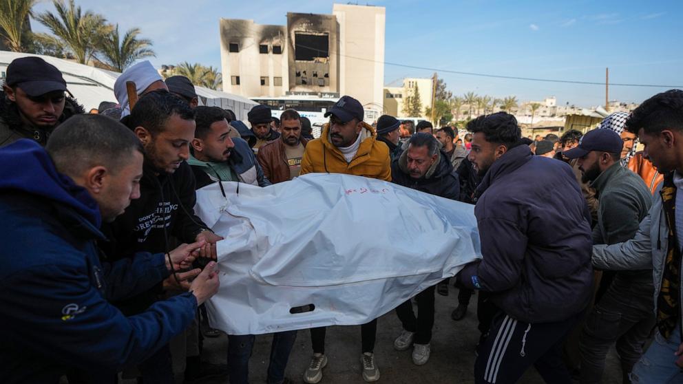 PHOTO: Palestinians carry white sacks containing the bodies of those killed in overnight Israeli airstrikes on the Khan Younis refugee camp, in the southern Gaza Strip, on Jan. 4, 2025.