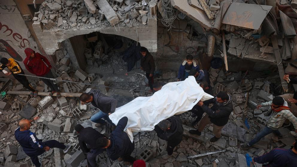 PHOTO: People pull out bodies from the rubble of a building destroyed in an Israeli strike on the Bureij camp in the central Gaza Strip on Jan. 8, 2025.