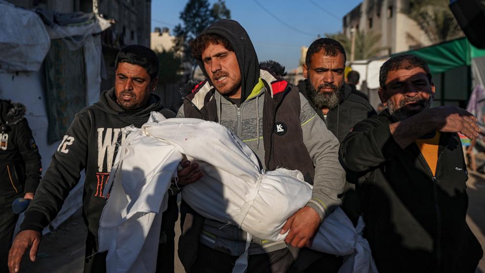 PHOTO: Palestinians carry the body of a relative killed in the Israeli bombardment of the Gaza Strip, at Al-Aqsa Hospital in Deir Al-Balah, on Jan. 8, 2025.