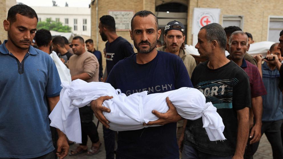 PHOTO: A mourner carries the body of a child during the funeral of Palestinians who, according to the medics, were killed in overnight Israeli strikes, at Al-Ahli Arab Hospital in Gaza City, on Oct. 29, 2025.
