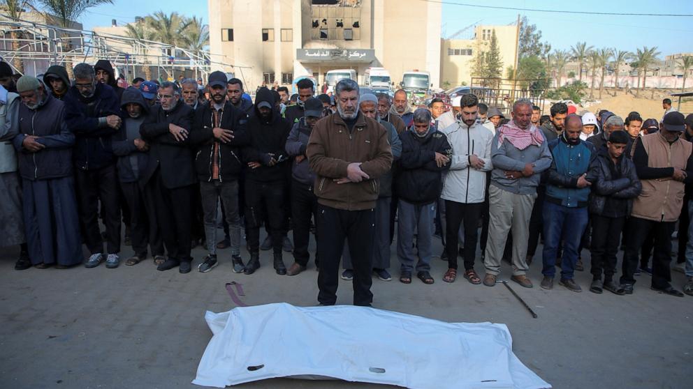 PHOTO: Mourners pray next to the body of Palestinian woman, Hanaa Mansour, who was killed in an Israeli strike on a tent camp sheltering displaced people, at Nasser Hospital in Khan Younis, southern Gaza Strip, on Dec. 18, 2024.