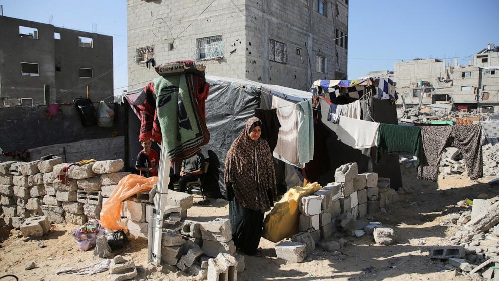 PHOTO: A displaced Palestinian woman, Makram Hamdouna, walks outside her shelter in Khan Younis in the southern Gaza Strip on Dec. 19, 2024.