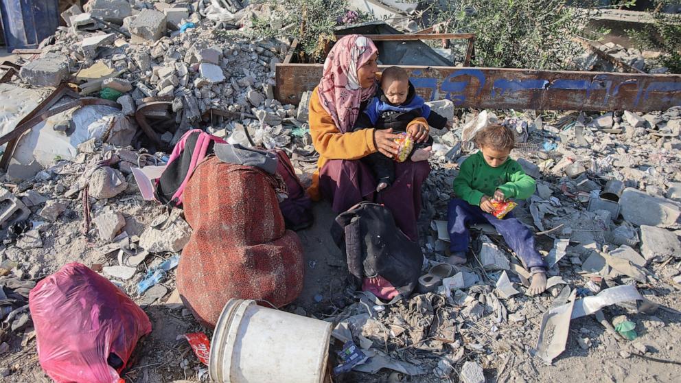 PHOTO: A woman rests with her children on the outskirts of Gaza City as Palestinians flee from Beit Lahiya in the north of the strip, on Nov. 5, 2024.