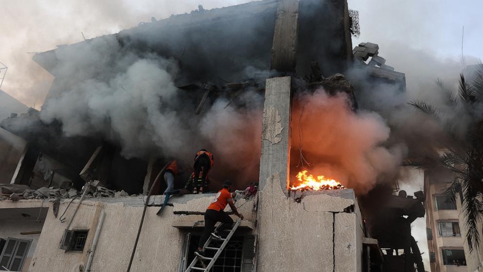 PHOTO: Civil defense personnel search a burning house targeted by Israeli airstrikes in Gaza City, on Nov. 22, 2025.