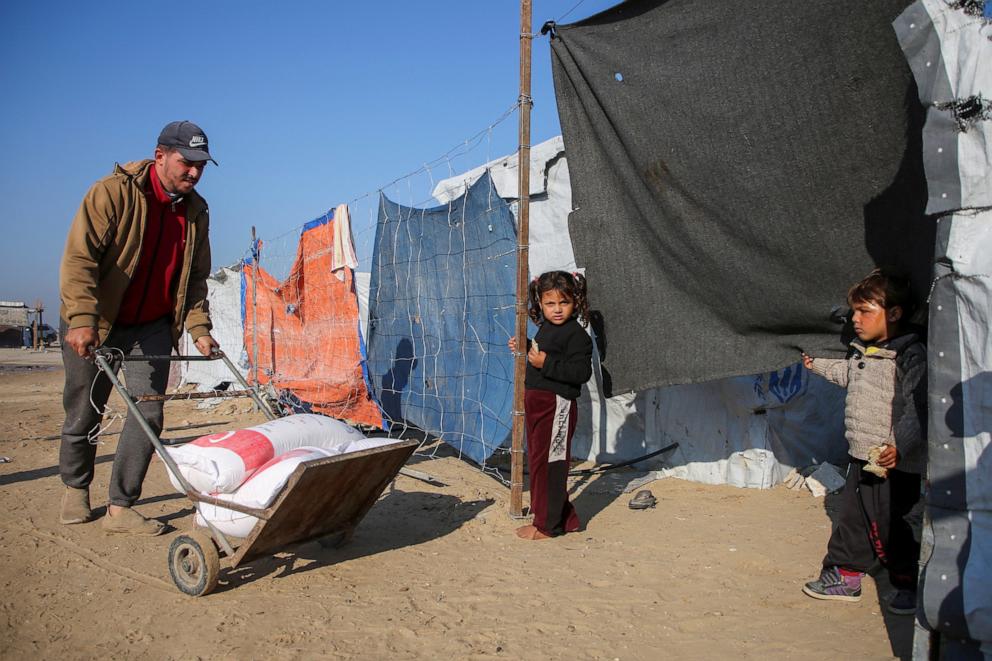 PHOTO: A displaced Palestinian man pushes a cart to his tent where his children wait for him in Khan Younis in the southern Gaza Strip, on Dec. 3, 2024.