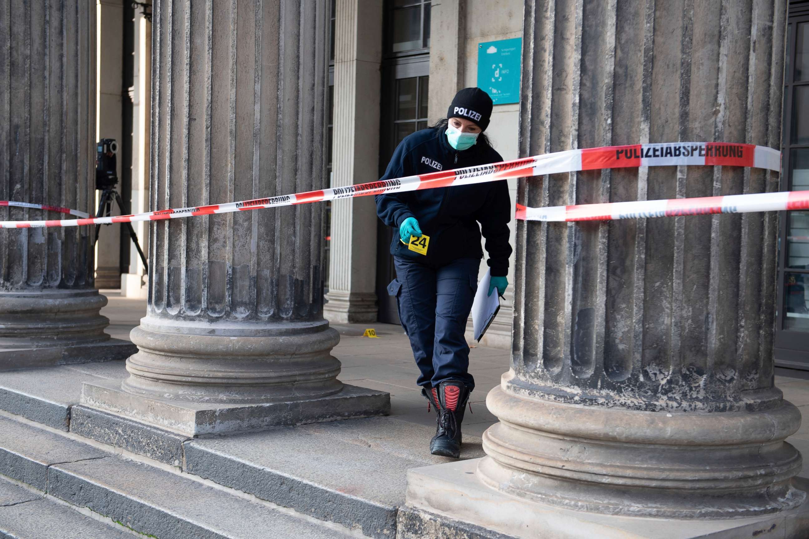 PHOTO: A police officer walks behind a caution tape at the Schinkelwache building in Dresden Monday, Nov. 25, 2019. Authorities in Germany say thieves have carried out a brazen heist at Dresden's Green Vault. (Sebastian Kahnert/dpa via AP)