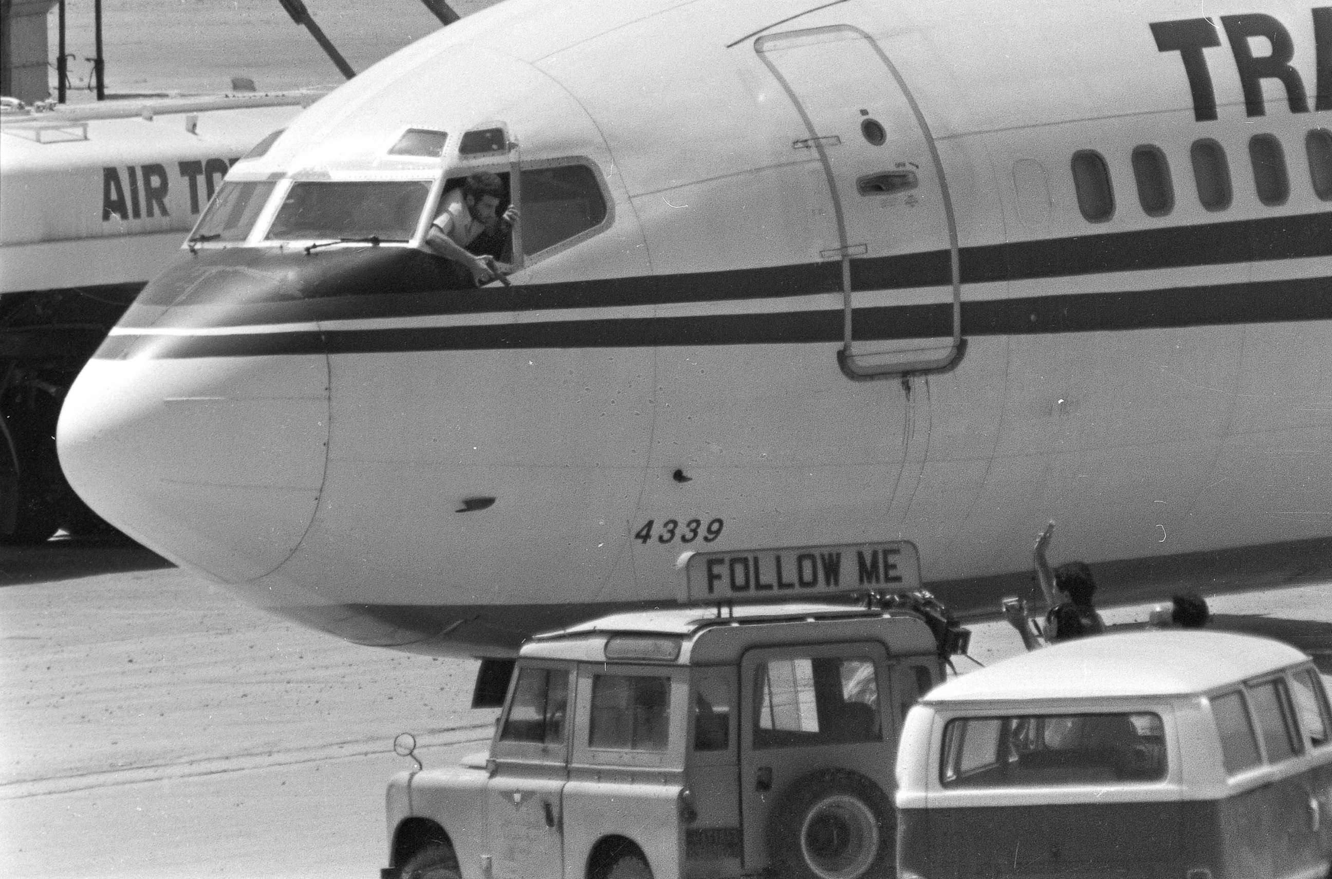 PHOTO: FILE - In this Wednesday, June 19, 1985 file photo, a hijacker points a weapon toward an ABC news media crew from the window of the cockpit of the Trans World Airlines jet at Beirut International Airport, Lebanon.