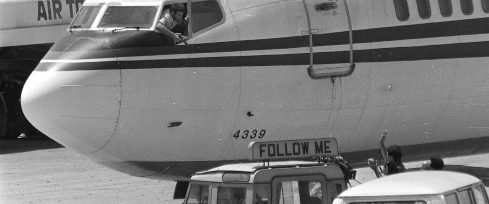 PHOTO: FILE - Σε αυτή την Τετάρτη, 19 Ιουνίου 1985 αρχείο φωτογραφίας, ένας αεροπειρατής σηματοδοτεί ένα όπλο προς ένα πλήρωμα ABC ειδησεογραφικών μέσων από το παράθυρο του πιλοτηρίου του τζιπ Trans World Airlines στο Διεθνές Αεροδρόμιο της Βηρυτού, Λίβανο.